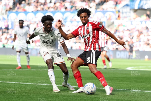 220826 - Swansea City v Sheffield United - Sky Bet Championship - Moussa Yeo of Swansea City puts pressure on Sam McCallum of Sheffield United as he clears the ball