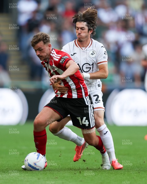 220826 - Swansea City v Sheffield United - Sky Bet Championship - Josh Key of Swansea City fouls Harrison Burrows of Sheffield United 