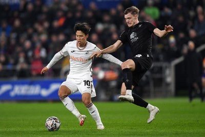 120225 - Swansea City v Sheffield Wednesday - Sky Bet Championship - Eom Ji-Sung of Swansea City is challenged by Svante Ingelsson of Sheffield Wednesday