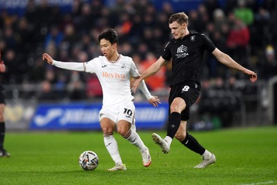 120225 - Swansea City v Sheffield Wednesday - Sky Bet Championship - Eom Ji-Sung of Swansea City is challenged by Svante Ingelsson of Sheffield Wednesday