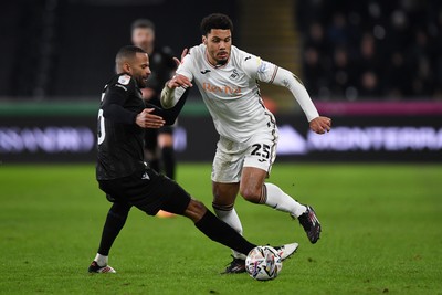 120225 - Swansea City v Sheffield Wednesday - Sky Bet Championship - Myles Peart-Harrris of Swansea City is challenged by Michael Ihiekwe of Sheffield Wednesday