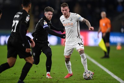 120225 - Swansea City v Sheffield Wednesday - Sky Bet Championship - Josh Tymon of Swansea City is challenged by Josh Windass of Sheffield Wednesday