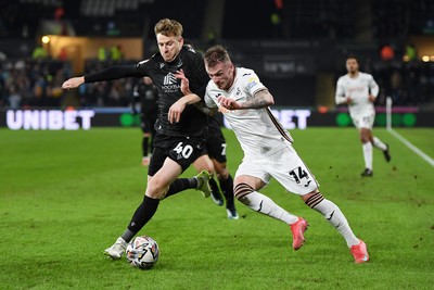 120225 - Swansea City v Sheffield Wednesday - Sky Bet Championship - Josh Tymon of Swansea City is challenged by Stuart Armstrong of Sheffield Wednesday