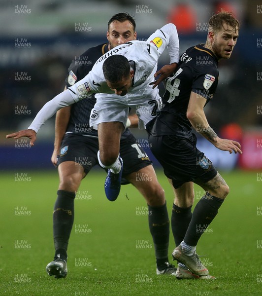 151218 - Swansea City v Sheffield Wednesday - SkyBet Championship - Kyle Naughton of Swansea City is tackled by Ashley Baker of Sheffield Wednesday