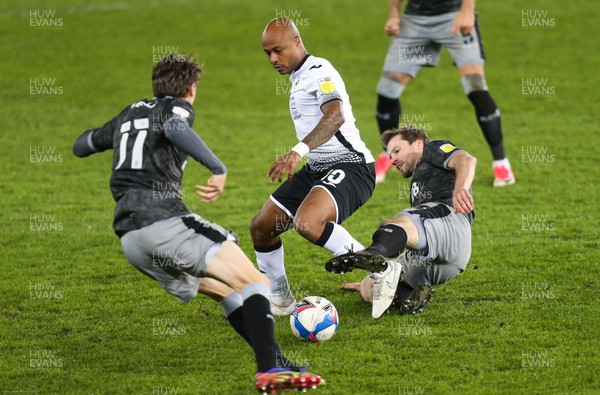 251120 - Swansea City v Sheffield Wednesday, Sky Bet Championship - Andre Ayew of Swansea City takes on Julian Borner of Sheffield Wednesday and Adam Reach of Sheffield Wednesday