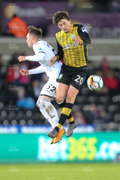 270218 - Swansea City v Sheffield Wednesday, FA Cup Fifth Round Replay - Connor Roberts of Swansea City and Adam Reach of Sheffield Wednesday compete for the ball