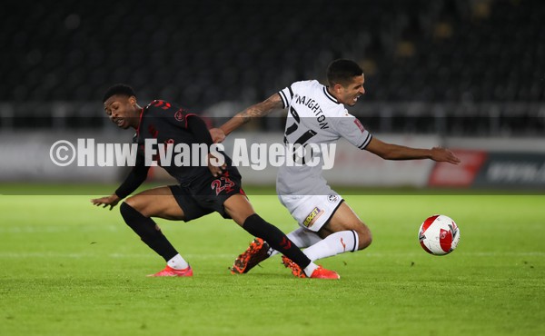 080122 - Swansea City v Southampton, FA Cup - Nathan Tella of Southampton and Kyle Naughton of Swansea City compete for the ball