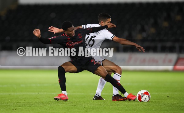 080122 - Swansea City v Southampton, FA Cup - Nathan Tella of Southampton and Kyle Naughton of Swansea City compete for the ball