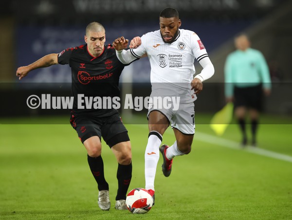 080122 - Swansea City v Southampton, FA Cup - Olivier Ntcham of Swansea City holds off Oriol Romeu of Southampton