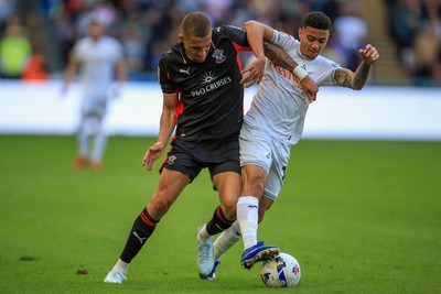 180426 - Swansea City v Southampton - Sky Bet Championship - Nathan Wood of Southampton battles for the ball with Gustavo Nunes of Swansea City