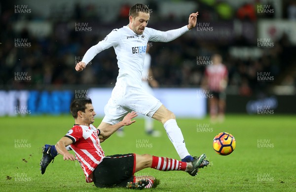 310117 - Swansea City v Southampton - Premier League - Gylfi Sigurdsson of Swansea City is tackled by Cedric Soares of Southampton