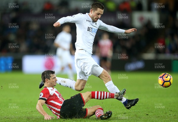 310117 - Swansea City v Southampton - Premier League - Gylfi Sigurdsson of Swansea City is tackled by Cedric Soares of Southampton