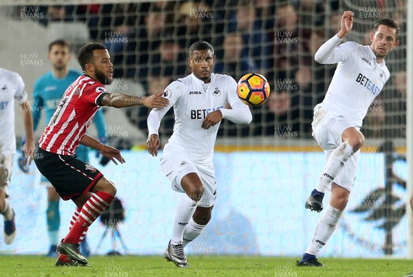 310117 - Swansea City v Southampton - Premier League - Luciano Narsingh and Gylfi Sigurdsson challenge Fraser Forster of Southampton for the ball