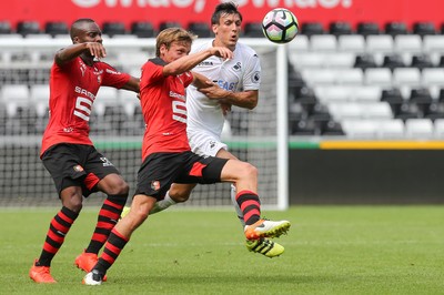 060816 -  Swansea City v Stade Rennais, Pre-season Friendly - Jack Cork of Swansea City and Clement Chantome of Stade Rennais compete for the ball