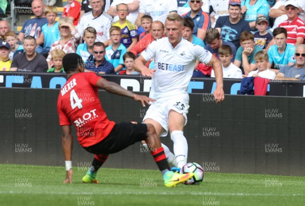 060816 -  Swansea City v Stade Rennais, Pre-season Friendly - Stephen Kingsley of Swansea City is tackled by Pedro Mendes of Stade Rennais