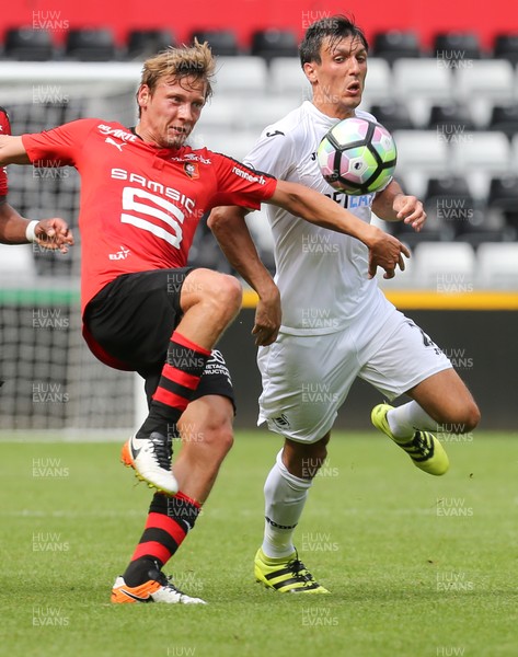 060816 -  Swansea City v Stade Rennais, Pre-season Friendly - Jack Cork of Swansea City and Clement Chantome of Stade Rennais compete for the ball