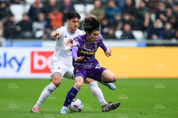 070326 - Swansea City v Stoke City - Sky Bet Championship - Marko Stamenic of Swansea City battles for the ball with Tatsuki Seko of Stoke City