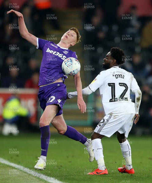 090419 - Swansea City v Stoke City - SkyBet Championship - Sam Clucas of Stoke City and Nathan Dyer of Swansea City go for the ball
