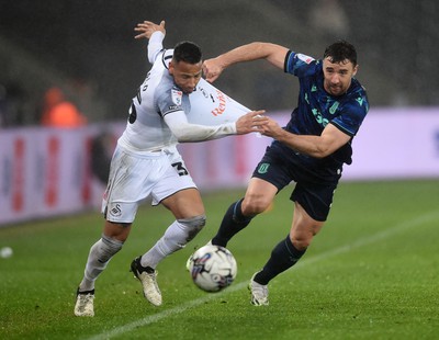 100424 - Swansea City v Stoke City - Sky Bet Championship - Ronald of Swansea City is challenged by Enda Stevens of Stoke City 