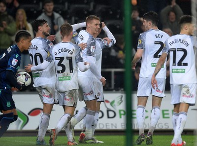 100424 - Swansea City v Stoke City - Sky Bet Championship - Swansea players celebrate after scoring a penalty