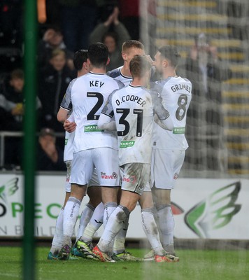 100424 - Swansea City v Stoke City - Sky Bet Championship - Swansea players celebrate after scoring a penalty