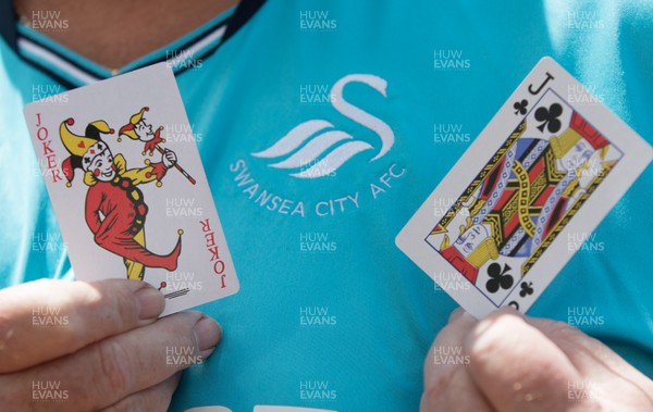 130518 - Swansea City v Stoke City, Premier League - A protester shows playing cards indicating his view of the situation Swansea City find themselves in during a protest outside the Liberty Stadium as Swansea City prepare to take on Stoke City in the final Premier League match of the season