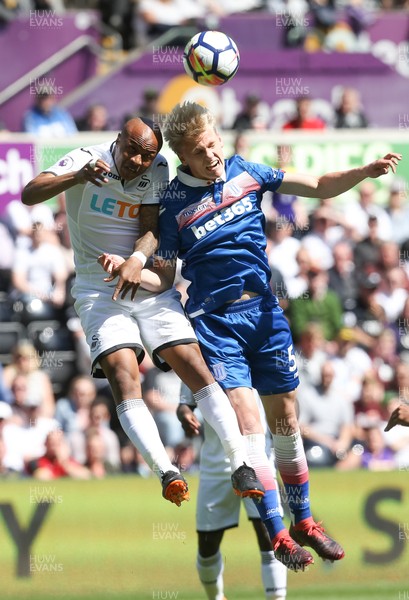 130518 - Swansea City v Stoke City, Premier League - Andre Ayew of Swansea City looks to win the ball as he challenges Lasse Sorensen of Stoke City
