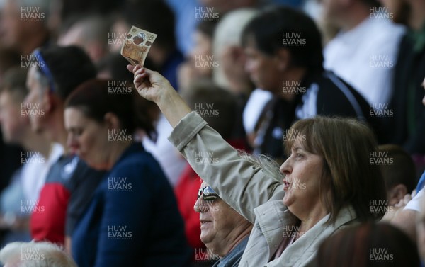 130518 - Swansea City v Stoke City, Premier League - A fan waves a 10 pound note on the 28th minute in protest at the American owners