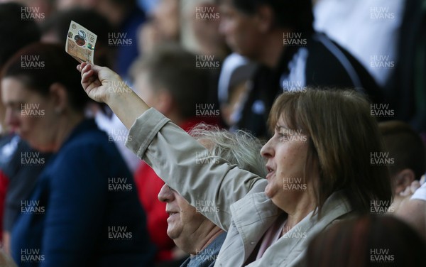 130518 - Swansea City v Stoke City, Premier League - A fan waves a 10 pound note on the 28th minute in protest at the American owners