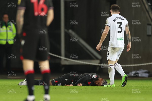 210223 - Swansea City v Stoke City, EFL Sky Bet Championship - Ryan Manning of Swansea City goes to check on Tyrese Campbell of Stoke City after he takes a heavy fall
