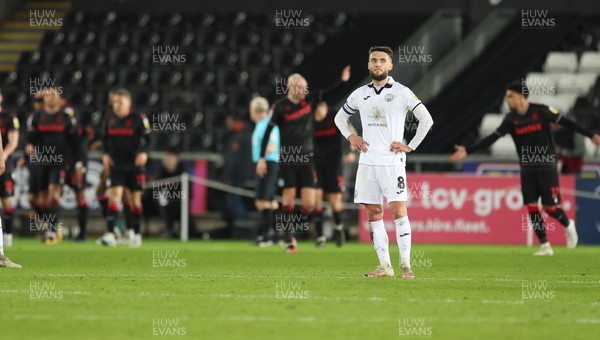 210223 - Swansea City v Stoke City, EFL Sky Bet Championship - Matt Grimes of Swansea City looks on as Stoke celebrate their third goal