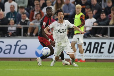 010926 Swansea City v Watford, EFL Sky Bet Championship - Ji-Sung Eom of Swansea City is brought down by Omar Haktab Traore of Watford