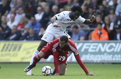 230917 - Swansea City v Watford, Premier League - Wilfried Bony of Swansea City tangles with Etienne Capoue of Watford as they compete for the ball