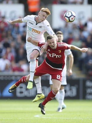 230917 - Swansea City v Watford, Premier League - Sam Clucas of Swansea City challenges Tom Cleverley of Watford for the ball 