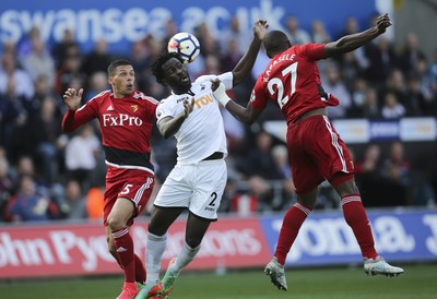 230917 - Swansea City v Watford, Premier League - Wilfried Bony of Swansea City gets between Jose Holebas of Watford and Christian Kabasele of Watford as he looks to head at goal