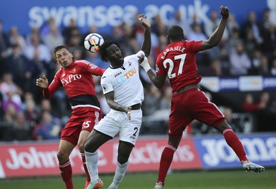 230917 - Swansea City v Watford, Premier League - Wilfried Bony of Swansea City gets between Jose Holebas of Watford and Christian Kabasele of Watford as he looks to head at goal