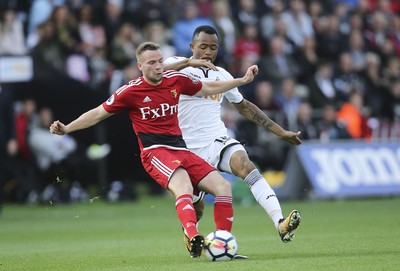 230917 - Swansea City v Watford, Premier League - Tom Cleverley of Watford is challenged by Jordan Ayew of Swansea City