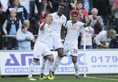 230917 - Swansea City v Watford, Premier League - Tammy Abraham of Swansea City, centre, celebrates with Roque Mesa of Swansea City and Kyle Naughton of Swansea City after scoring goal