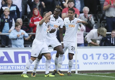 230917 - Swansea City v Watford, Premier League - Tammy Abraham of Swansea City, centre, celebrates with Roque Mesa of Swansea City and Kyle Naughton of Swansea City after scoring goal