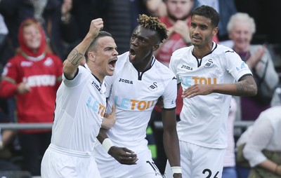 230917 - Swansea City v Watford, Premier League - Tammy Abraham of Swansea City, centre, celebrates with Roque Mesa of Swansea City and Kyle Naughton of Swansea City after scoring goal