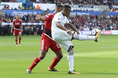 230917 - Swansea City v Watford, Premier League - Jordan Ayew of Swansea City controls the ball under pressure from Molla Wague of Watford