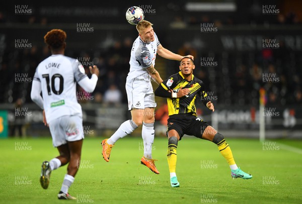 241023 - Swansea City v Watford - EFL SkyBet Championship - Kristian Pedersen of Swansea City goes up for the ball against Thomas Ince of Watford