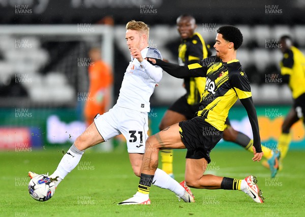 241023 - Swansea City v Watford - EFL SkyBet Championship - Ollie Cooper of Swansea City is tackled by Jamal Lewis of Watford
