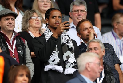 230825 - Swansea City v Watford FC - SkyBet Championship - Snoop Dogg�s son Cordell Broadus watches the game from the stands with Swansea City owner and shareholder Brett Cravatt