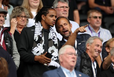 230825 - Swansea City v Watford FC - SkyBet Championship - Snoop Dogg�s son Cordell Broadus watches the game from the stands with Swansea City owner and shareholder Brett Cravatt