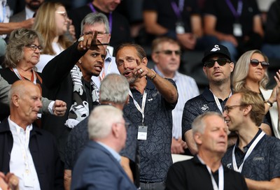 230825 - Swansea City v Watford FC - SkyBet Championship - Snoop Dogg�s son Cordell Broadus watches the game from the stands with Swansea City owner and shareholder Brett Cravatt and Scott Hochstadt