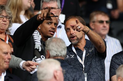 230825 - Swansea City v Watford FC - SkyBet Championship - Snoop Dogg�s son Cordell Broadus watches the game from the stands with Swansea City owner and shareholder Brett Cravatt 