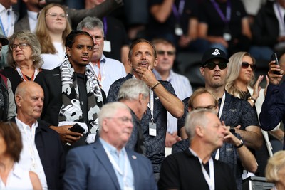 230825 - Swansea City v Watford FC - SkyBet Championship - Snoop Dogg�s son Cordell Broadus watches the game from the stands with Swansea City owner and shareholder Brett Cravatt and Scott Hochstadt