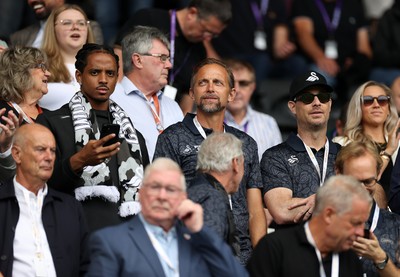 230825 - Swansea City v Watford FC - SkyBet Championship - Snoop Dogg�s son Cordell Broadus watches the game from the stands with Swansea City owner and shareholder Brett Cravatt and Scott Hochstadt