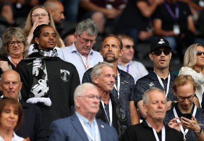 230825 - Swansea City v Watford FC - SkyBet Championship - Snoop Dogg�s son Cordell Broadus watches the game from the stands with Swansea City owner and shareholder Brett Cravatt and Scott Hochstadt